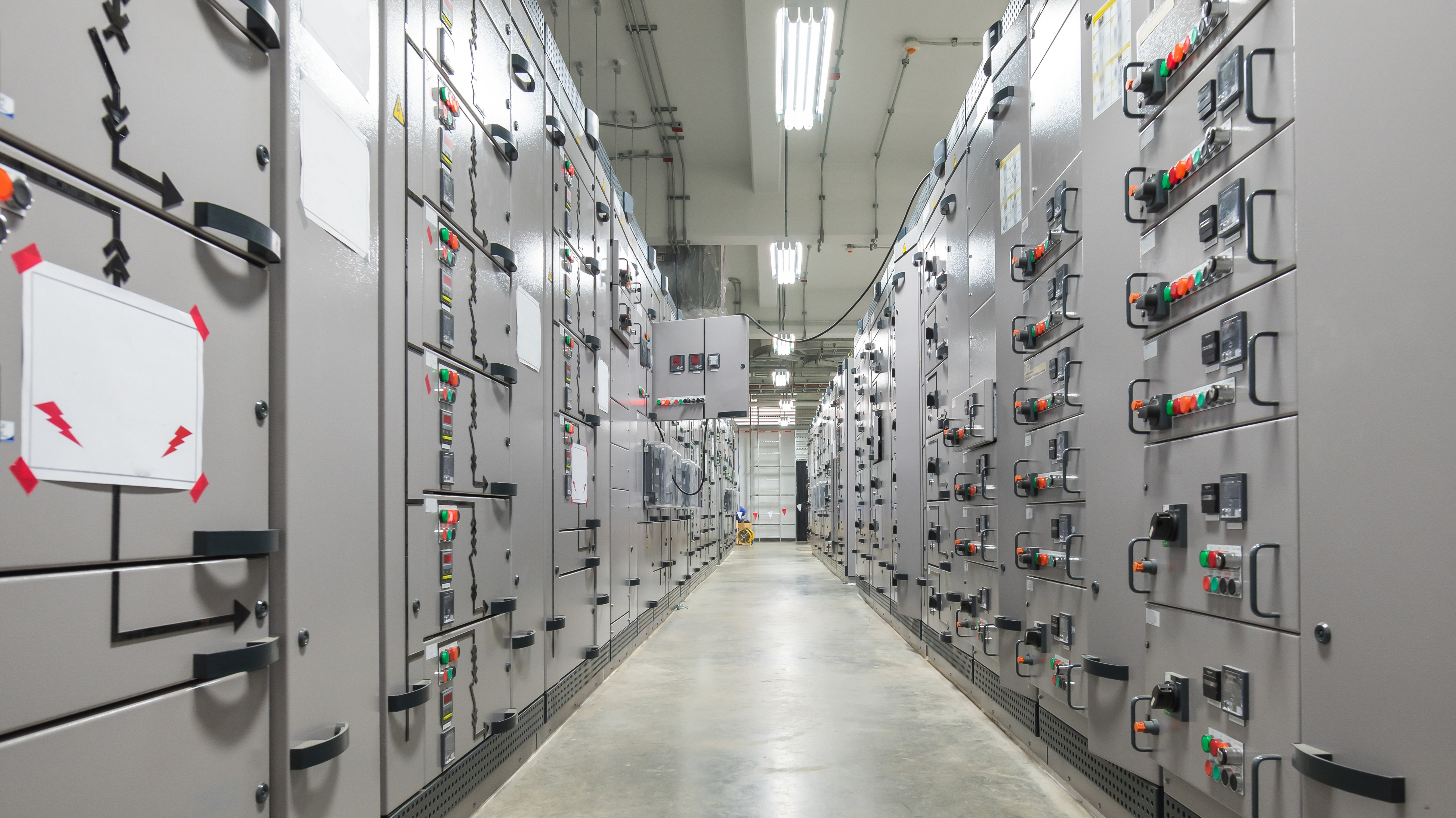 SMEC engineers assembling and wiring an industrial control panel in the fabrication facility